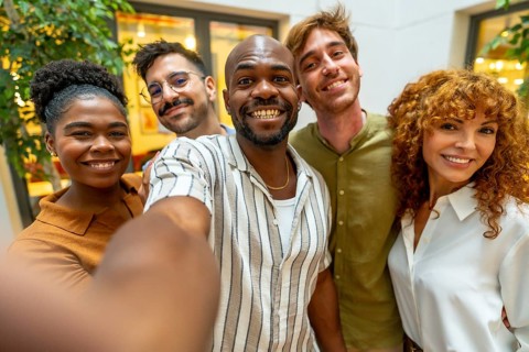 Group of happy multiracial business colleagues, including men and women, posing for a cheerful