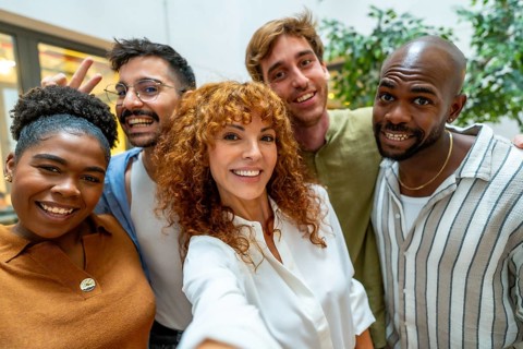 Diverse and happy colleagues pausing from work for a casual meeting or teamwork moment, showing