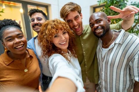 Happy business colleagues enjoying teamwork and a moment together, depicting diversity and