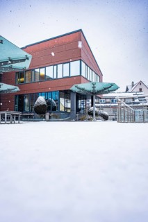 Modern town hall building with glass fronts in a snowy winter landscape, Gechingen, Calw district,