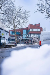 A modern street with snow-covered buildings and cars in winter, Town Hall, Gechingen, Calw
