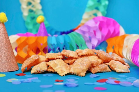 German pastries called 'Mutzen pastries or Muzenblätter' with powdered sugar on festive background.