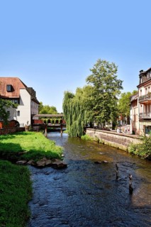Ettlingen, Germany - August 13th 2025: Alb brook in historic center of Ettlingen, Germany. Small