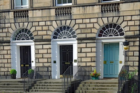 Three Georgian doors with symmetrical windows and stairs in front of them, Newtown, Edinburgh,
