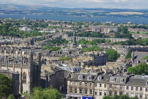 A panorama of buildings and water in a vast cityscape, view from Castle Hill, Edinburgh, Scotland,