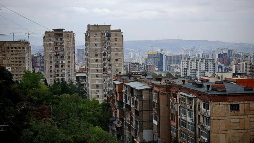 Urban panorama with high-rise buildings in a residential district of Tbilisi and hilly landscape,