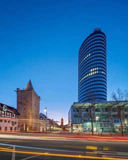 Johannistor and JenTower with light trails from cars at dusk, high-rise building, glass façade,