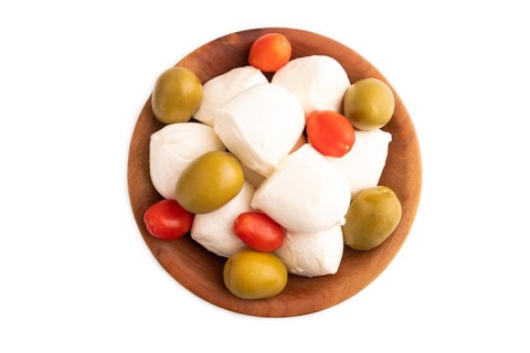 White Mozzarella cheese, with tomatoes and olives in wooden bowl Isolated on white background, top