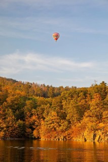 Hot air balloons over the Brno Reservoir (Brnenská prehrada) on the Svratka River on a sunny autumn