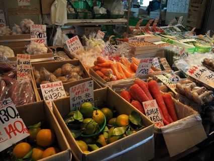 Market stand with a selection of fresh vegetables and fruits in bright colors, Tsukiji Outer