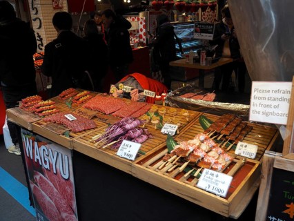 Lively market stand with various meats, including Wagyu, and other foods, Tsukiji Outer Market,