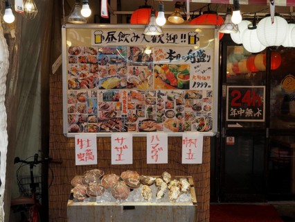 Market stand with food and menus on display, decorated with paper lanterns, Ameyoko Market, Tokyo,