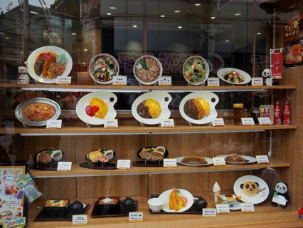 Restaurant window with various decorated food plates, Tokyo, Japan