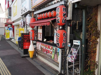 Small Japanese food stand with colorful lanterns on a street, Narita, Japan