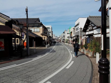 Empty street with traditional buildings and clear blue sky, Densha-michi street, Narita, Japan