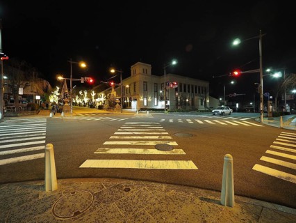 Night view of a quiet and illuminated city intersection with traffic lights, Chuo-dori street,