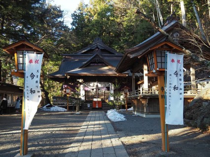 Traditional shrine surrounded by trees with wooden buildings and lanterns, Arakura Fuji
