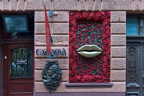 Bronze relief from Casanova, window with mouth and rose petals at Casanova restaurant, Lviv,