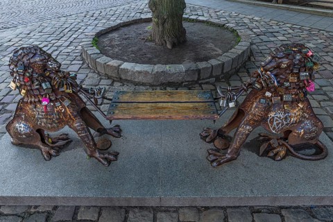 Lion figures with love locks holding a bench, Lviv, Ukraine