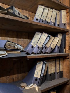 Shelves with dusty folders in the administration of a former GDR factory, Lost Place,
