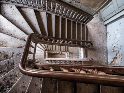 Staircase with wooden railing in a former sanatorium, Lost Place, Saxony-Anhalt, Germany