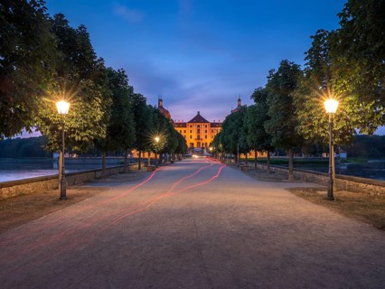 Avenue with lanterns as access to Moritzburg Castle, Augustus the Strong hunting lodge at dusk,