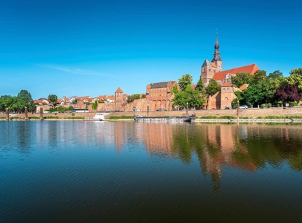 View across the Elbe harbor to the old town with St. Stephen's church and city wall, brick
