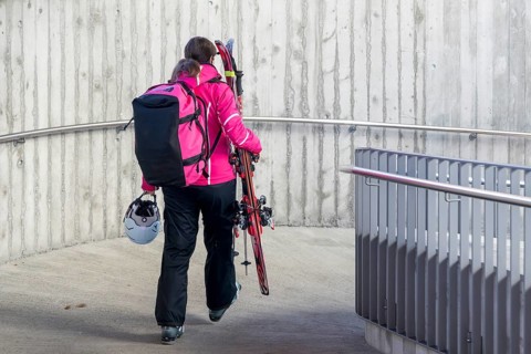 Woman with skiing equipment, Zweisimmen, Switzerland