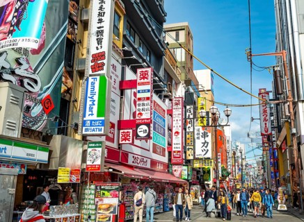Lots of colorful signs in a pedestrian zone with shops and restaurants, Dotonbori, Osaka, Japan