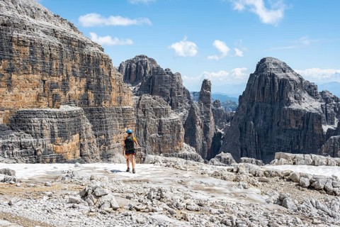 Hikers on the Sentiero Brentari hiking trail in front of cliffs, Brenta Mountains, Brenta-Adamello