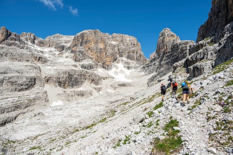 Hikers on hiking trail, behind Cima Margherita and Cima Tosa, Brenta Mountains, Brenta-Adamello
