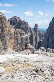 Hikers on the Sentiero Brentari hiking trail in front of cliffs, Brenta Mountains, Brenta-Adamello