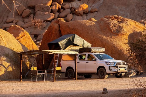 Camping vehicle with tent on rocky Spitzkoppe, Spitzkoppe, Namibia