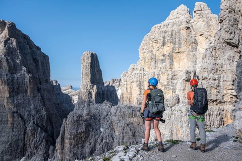 Mountaineers look at Campanile Alto pinnacle, Bocchette Centrale band trail, via ferrata in the