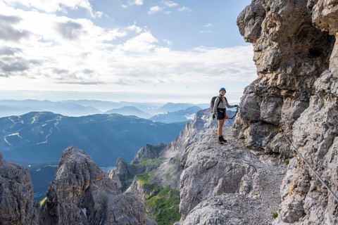 Climbers on a rock band, Bocchette Centrale band trail, via ferrata in the Brenta Mountains,