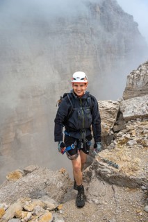 Happy mountaineer, Via Ferrata Oliva Detassis via ferrata in fog, rocky mountain peaks and mountain