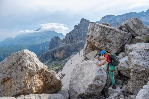 Female mountaineer on a hiking trail, rocky mountain landscape, Via Ferrata SOSAT via ferrata,