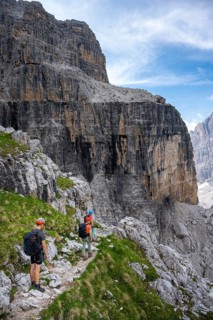 Three mountaineers on a hiking trail, rocky mountain landscape, Via Ferrata SOSAT via ferrata,