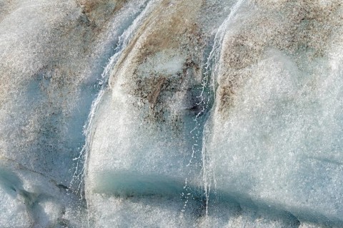 Water dripping from melting ice wall of Idabreen, Ida glacier calving into Liefdefjorden at