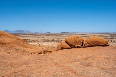 Bushman's paradise, vast, rocky desert under bright blue sky, Spitzkoppe, Namibia