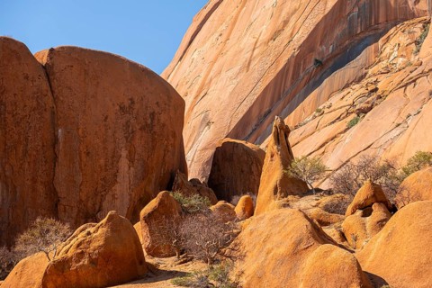 Elevated rock masses in warm tones under bright skies, Spitzkoppe, Namibia