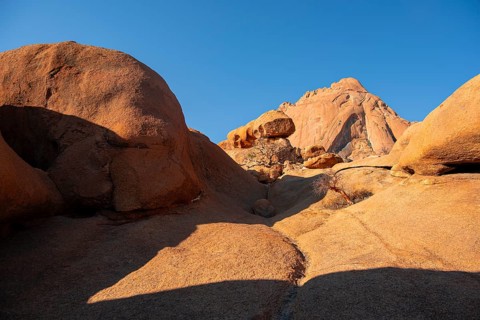 Reddish rocks under bright blue sky in the desert, Spitzkoppe, Namibia