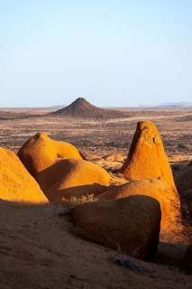 Red rocks rise above the vast dry plain of the Spitzkoppe Desert, Spitzkoppe, Namibia