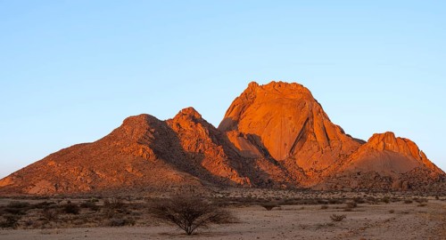 Spitzkoppe rocks at dusk with sparse vegetation in the foreground, Spitzkoppe, Namibia