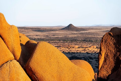 Impressive rock formations offer a wide view of the dry desert plain of Spitzkoppe, Spitzkoppe,