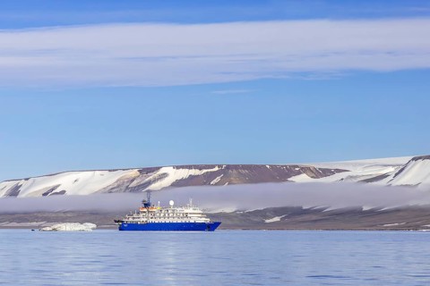 Antarctic cruise ship MV Sea Spirit of Poseidon Expeditions with eco-tourists cruising along the