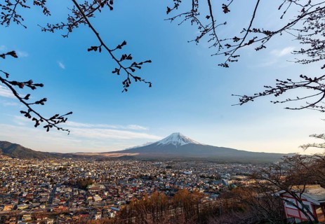 View of Mount Fuji volcano over Fujiyoshida City in evening light, at sunset, Arakurayama Sengen