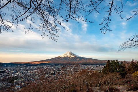 View of Mount Fuji volcano over Fujiyoshida City in morning light, at sunrise, Arakurayama Sengen