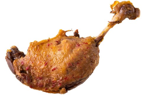 Roasted duck confit isolated. The duck leg is cooked slowly until tender and ready to serve. This