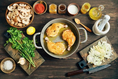 Top view of chicken poultry browning in oil. Culinary process of making dinner with sliced